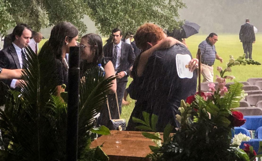 Buster Murdaugh, center, receives a hug in the rain during the funeral service for his brother, Paul, and mother, Maggie, on June 11 in Hampton, South Carolina.