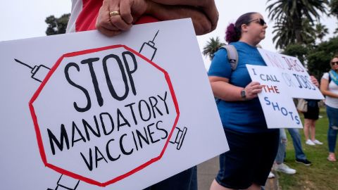 Anti-vaccination protesters holding signs take part in a rally against Covid-19 vaccine mandates, in Santa Monica, California, on August 29, 2021.