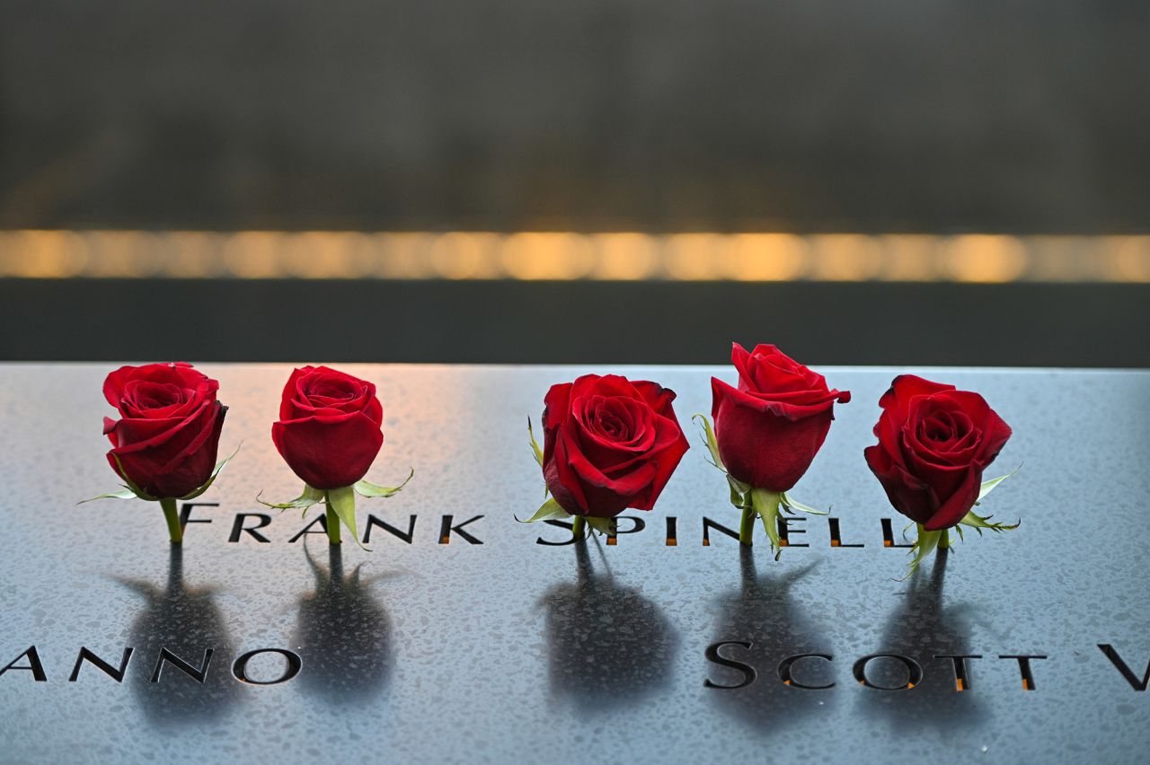 Flowers are placed at the name of Frank Spinelli at the New York memorial on Saturday.