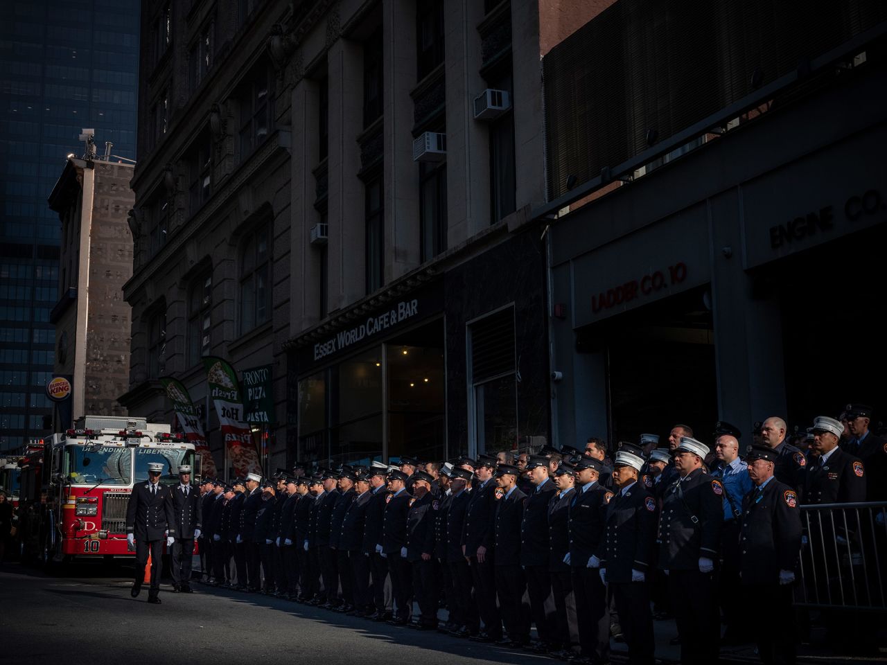 New York firefighters line the street during a ceremony marking when the first plane hit the World Trade Center.