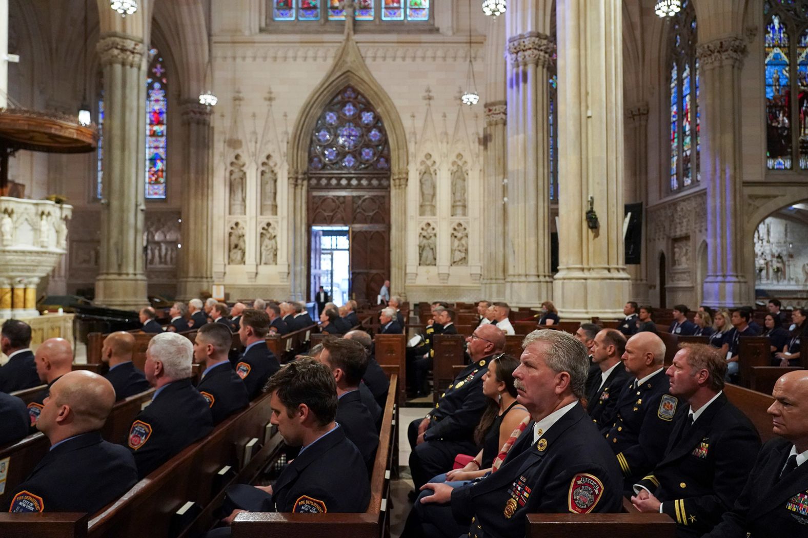 Firefighters and their family members attend a memorial service for fallen firefighters at St. Patrick's Cathedral in New York.