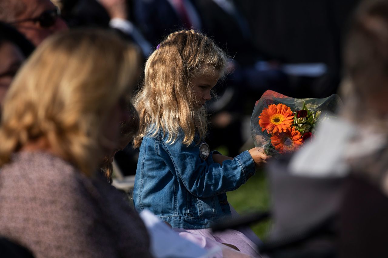 A young girl holds flowers during the ceremony near Shanksville.