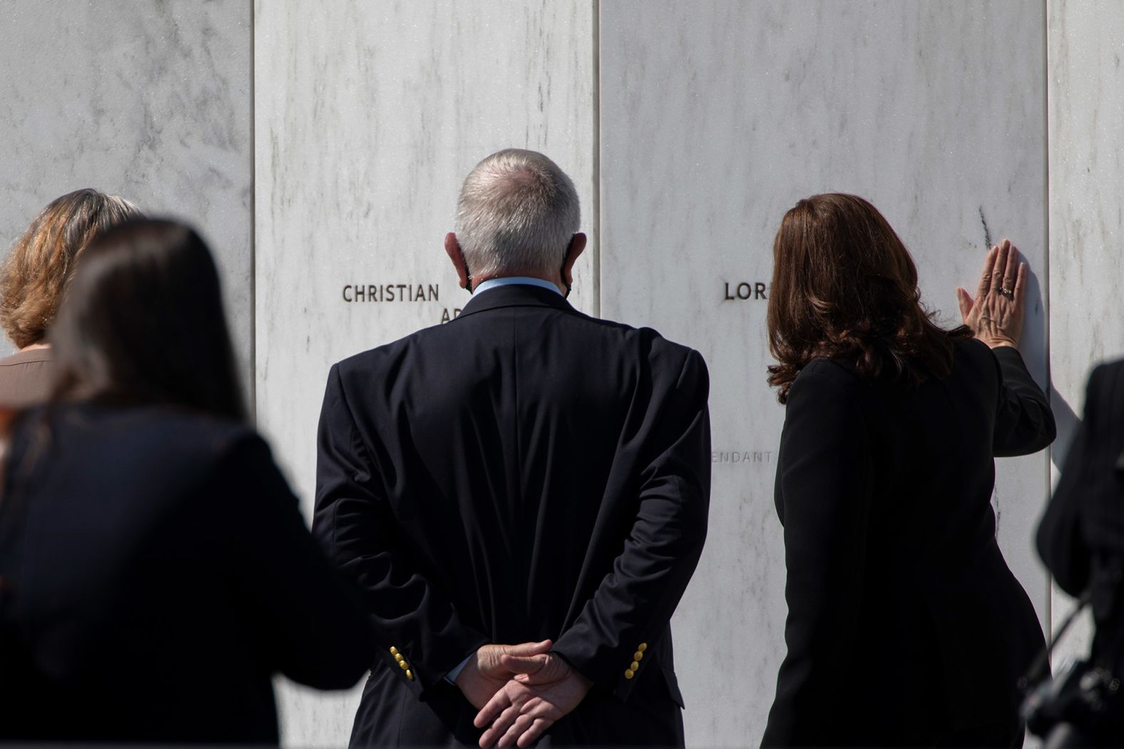 Vice President Kamala Harris touches the memorial wall near Shanksville. "What happened on Flight 93 told us then — and it still tells us — so much about the courage of those on board who gave everything they possibly could, about the resolve of the first responders who risked everything, and about the resilience of the American people," Harris said during the ceremony.
