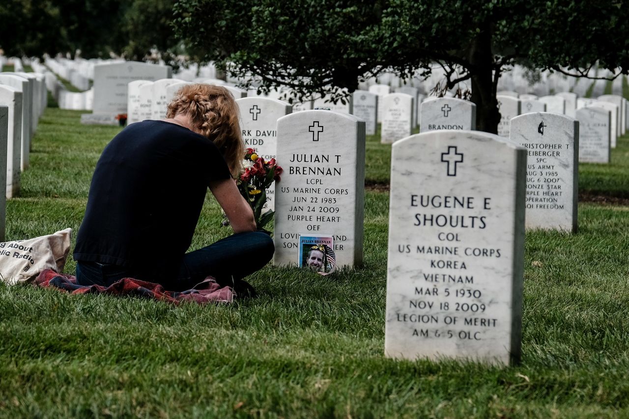 Marian Brennan sits at the headstone of her nephew Lance Cpl. Julian T. Brennan in Section 60 of Arlington National Cemetery, reserved for veterans of recent US conflicts.