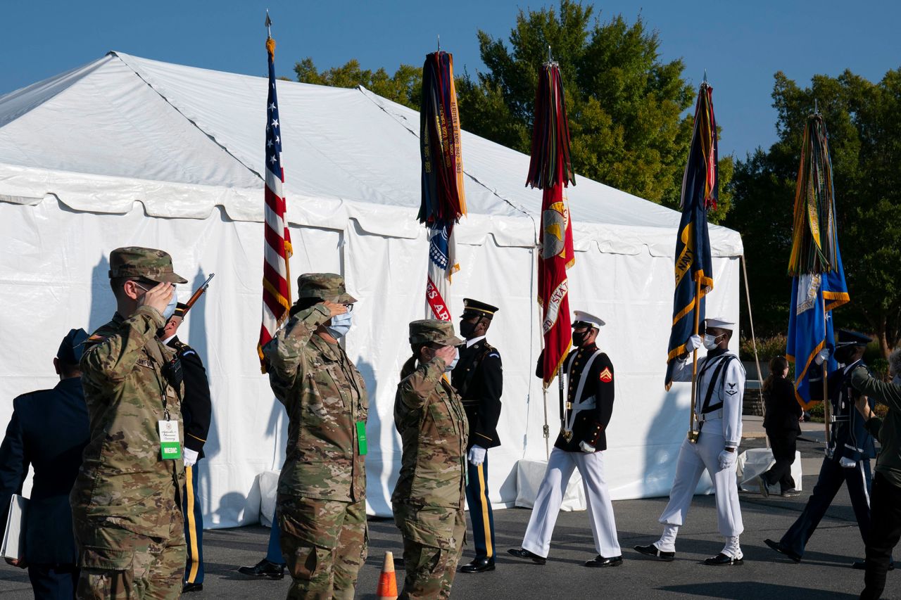 Members of the military salute the Color Guard during the ceremony at the Pentagon.
