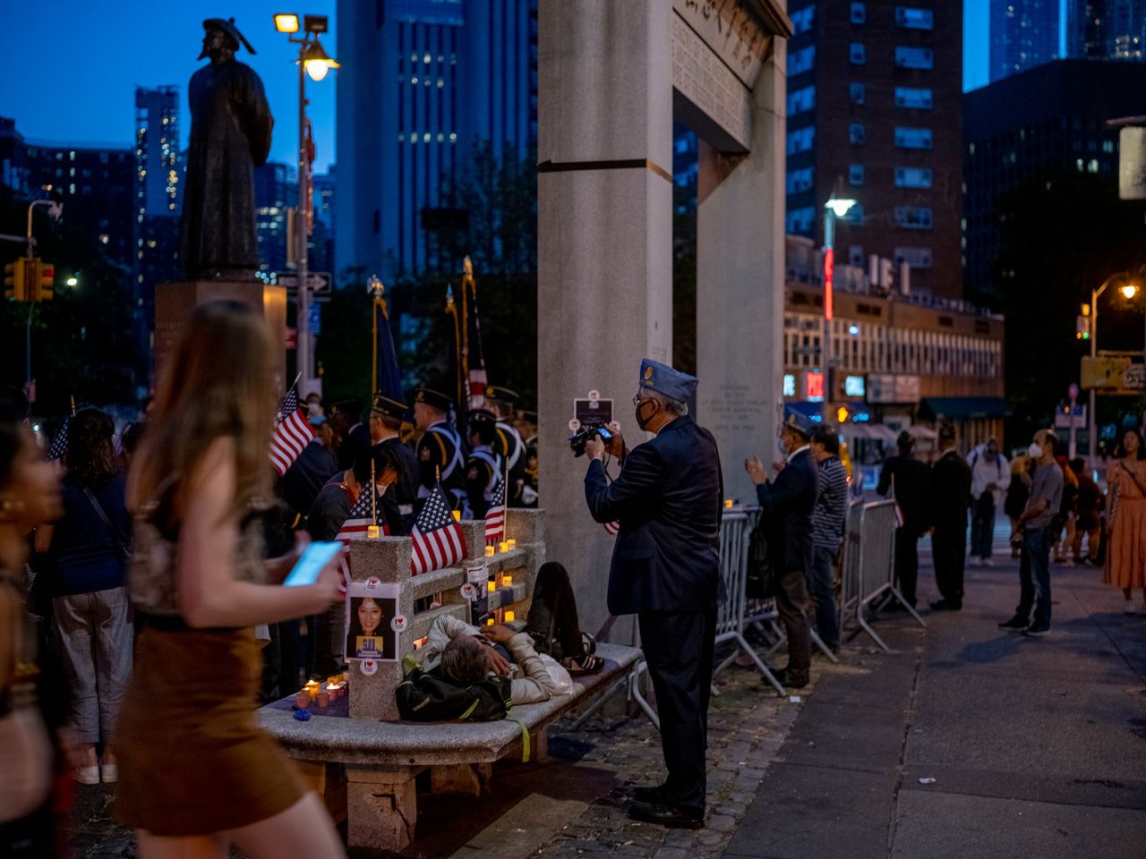 People watch a ceremony being held Saturday night in Chinatown in honor of Betty Ann Ong, the American Airlines flight attendant who alerted authorities to the hijacking before the first plane hit the World Trade Center.