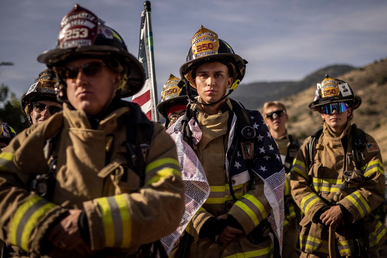 Firefighters pause for a moment of silence as they participate in the Colorado 9/11 Memorial Stair Climb at the Red Rocks Park and Amphitheatre in Morrison, Colorado. Participants walk nine laps around the Red Rocks Amphitheater, which is equivalent to the 110 floors of the World Trade Center.