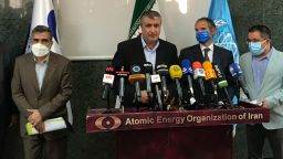 Head of Atomic Energy Organization of Iran, Mohammad Eslami, center, speaks during a joint press briefing with Director General of International Atomic Energy Agency, IAEA, Rafael Mariano Grossi, second right, in Tehran, Iran, Sunday, Sept. 12, 2021. Iran agreed Sunday to allow international inspectors to install new memory cards into surveillance cameras at its sensitive nuclear sites and to continue filming there, averting a diplomatic showdown this week. (Atomic Energy Organization of Iran via AP)