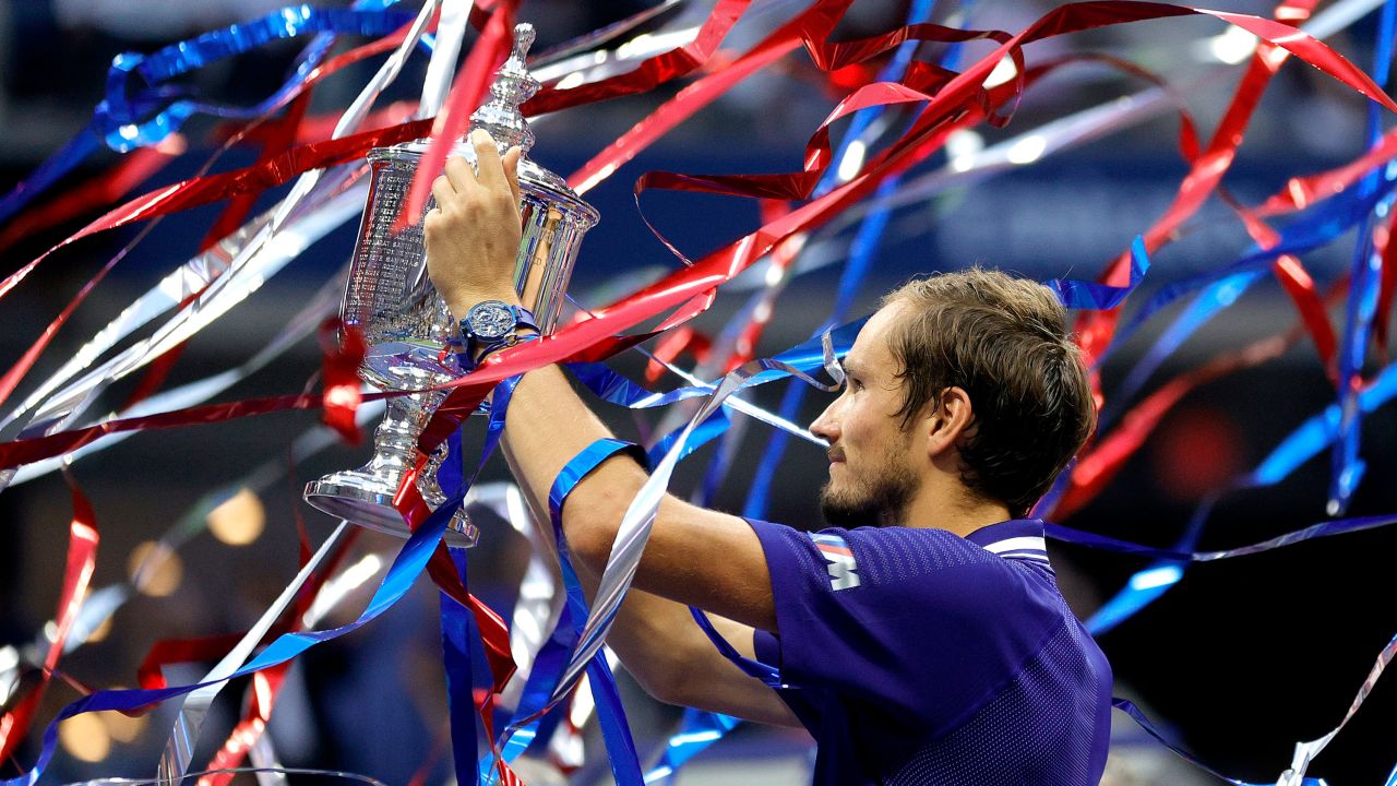 Medvedev celebrates with the US Open trophy.
