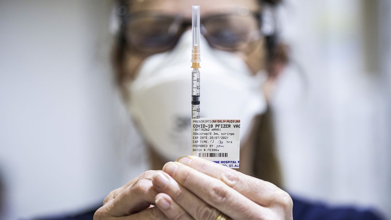 Staff are seen preparing Pfizer vaccine doses inside the Melbourne Showgrounds Covid-19 Vaccination Centre on July 20 in Melbourne, Australia.