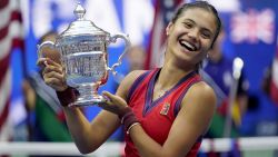 Emma Raducanu, of Britain, holds up the US Open championship trophy after defeating Leylah Fernandez, of Canada, during the women's singles final of the US Open tennis championships, Saturday, Sept. 11, 2021, in New York. (AP Photo/Seth Wenig)