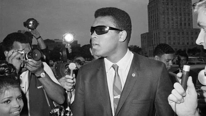 Muhammad Ali is seen outside the Federal Building in Houston after he heard a federal judge tell him to refile his plea to avoid the draft after his scheduled induction, April 27, 1967.  Ali had a "no comment," to questions asked on all subjects.