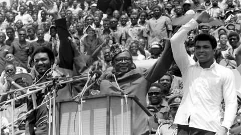 President Mobutu Sese Seko, center, as he raises the arms of heavyweight champ George Foreman, left, and Muhammad Ali in Kinshasa in 1974.