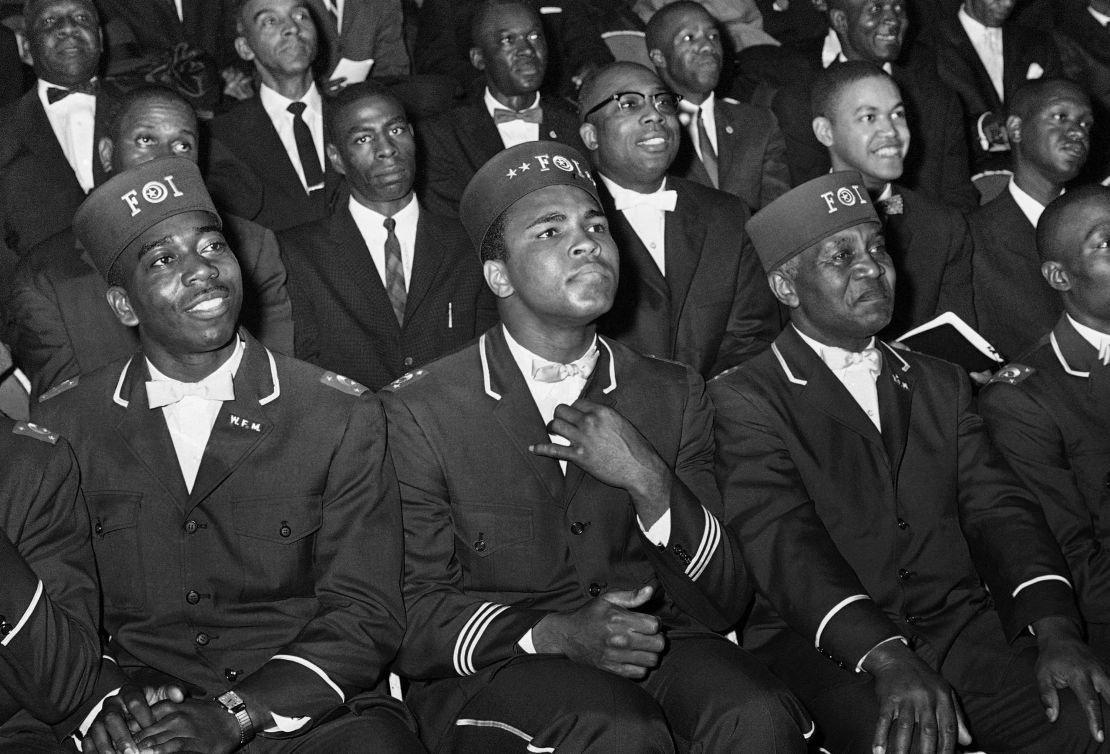 Muhammad Ali listens to Elijah Muhammad as he speaks to other black Muslims in Chicago.