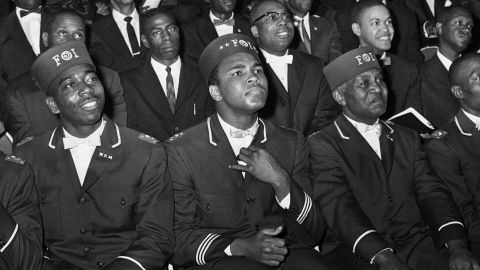 Muhammad Ali listens to Elijah Muhammad as he speaks to other black Muslims in Chicago.