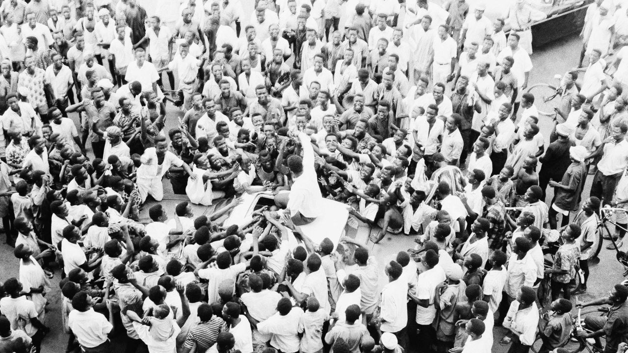 Nigerians crowd around Ali as he rides to his hotel in Lagos on June 1, 1964. Ali led the crowd in cheering himself as "King of the World." 