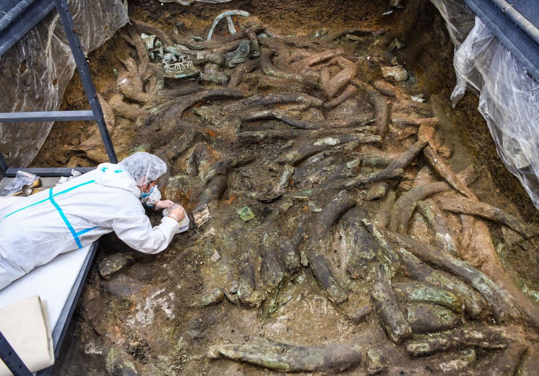 An archaeologist at work in one of the sacrificial pits.