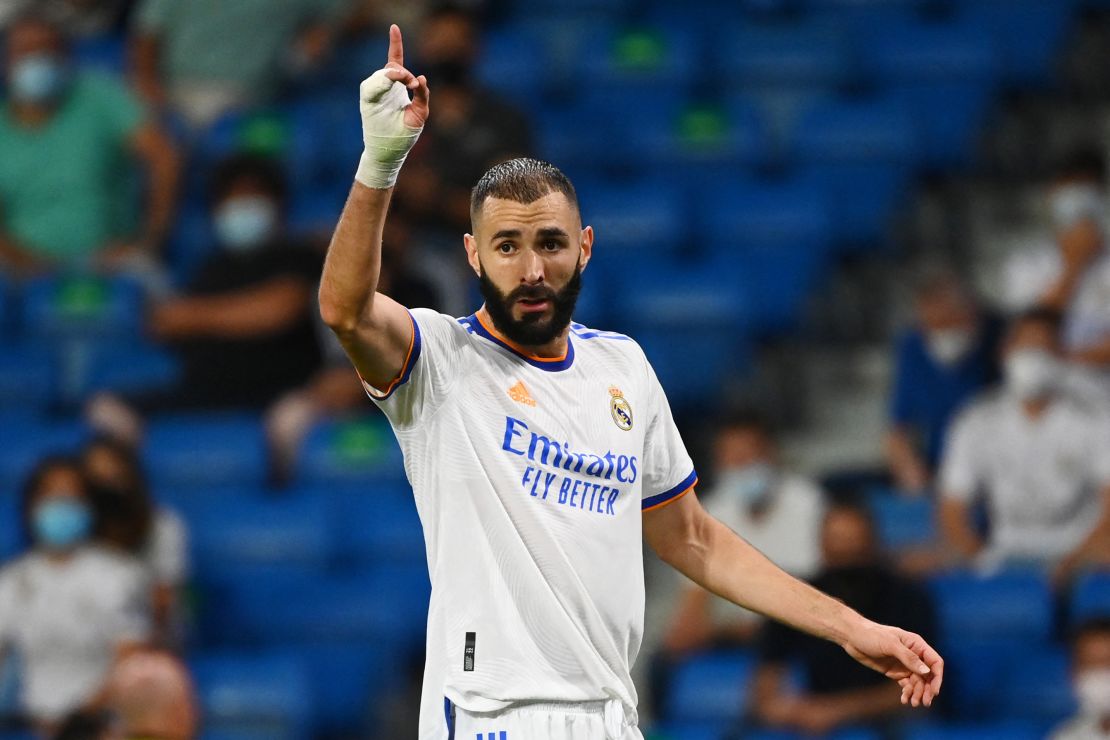 Real Madrid's French forward Karim Benzema gestures during the Spanish League football match between Real Madrid CF and RC Celta de Vigo at the Santiago Bernabeu stadium in Madrid on September 12, 2021.