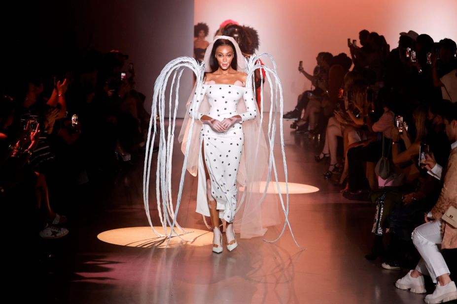 Winnie Harlow closed the Christian Cowan show in a cascading plume of angelic white feathers.