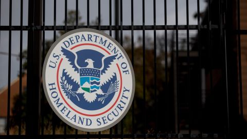 The U.S. Department of Homeland Security (DHS) seal hangs on a fence at the agency's headquarters in Washington, D.C., U.S., on Thursday, Dec. 11, 2014.