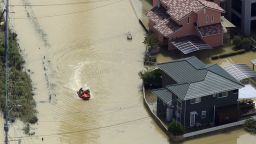 Local people are rescued by a boat as flooding due to heavy rain inundated Takeo City in western Japan on August 15, 2021.