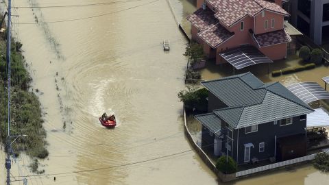 Local people are rescued by a boat as flooding due to heavy rain inundated Takeo City in western Japan on August 15, 2021.