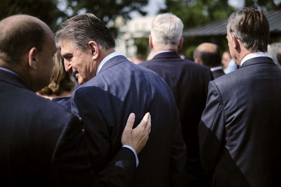 Sen. Joe Manchin, second left, during a bipartisan press conference to promote the infrastructure bill in July.