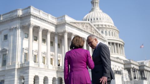 Senate Majority Leader Chuck Schumer speaks to House Speaker Nancy Pelosi outside the Capitol in June.