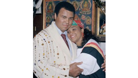 Muhammad Ali with his daughter Maryum "May May" Ali in 1988, wearing the boxing robe gifted by Elvis Presely that he would donate to New York's Hard Rock Café.