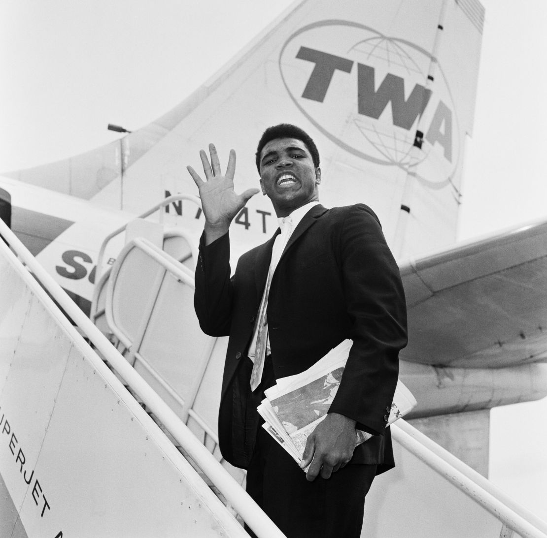 Cassius Clay, before he changed his name to Muhammad Ali, photographed en route back to the US after beating Henry Cooper in 1963.