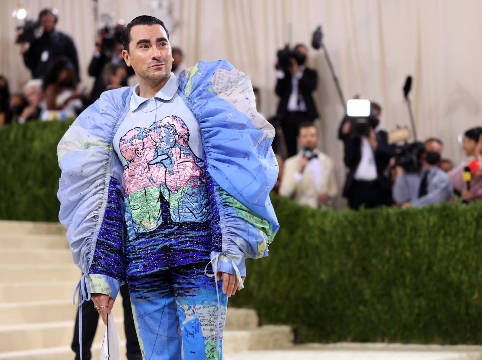"Schitt's Creek" star Dan Levy arrived in custom Loewe. The structural outfit featured artworks by artist David Wojnarowicz, depicting two men kissing, and was finished off with black embellished boots.