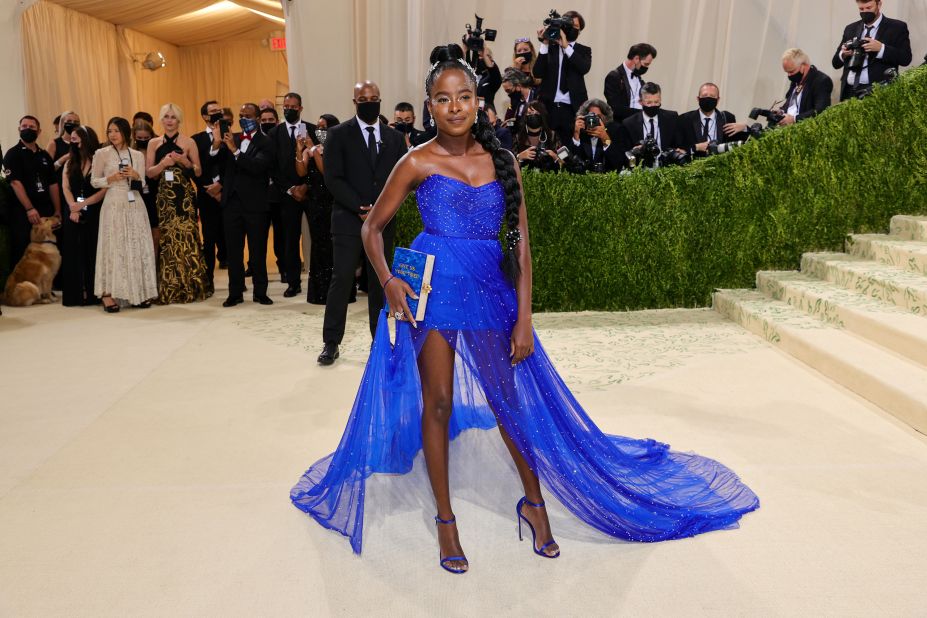 Met Gala co-chair Amanda Gorman wore a bespoke blue Vera Wang gown and a silver laurel crown. Representing a reimagined Statue of Liberty, she held an Edie Parker clutch that said "Give Me Your Tired" a reference to the poem at the statue's base.