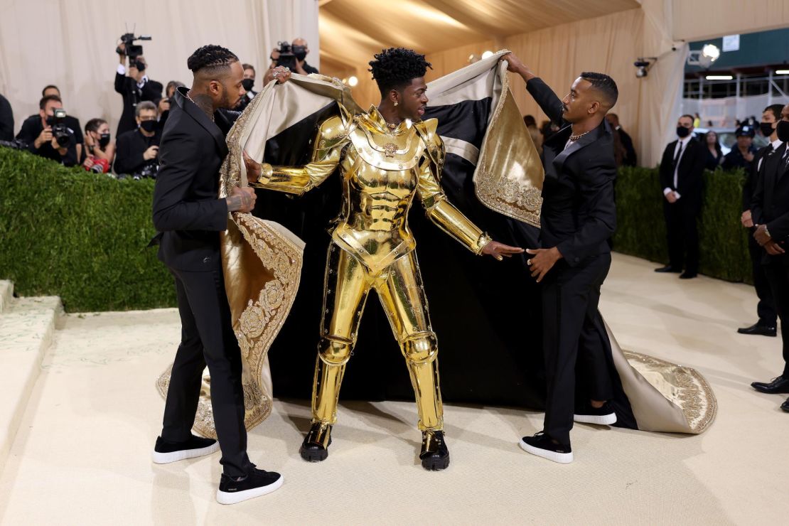 Lil Nas X made one of the evening's most dramatic entrances, revealing a gold suit of armor and, later, a gold jumpsuit.