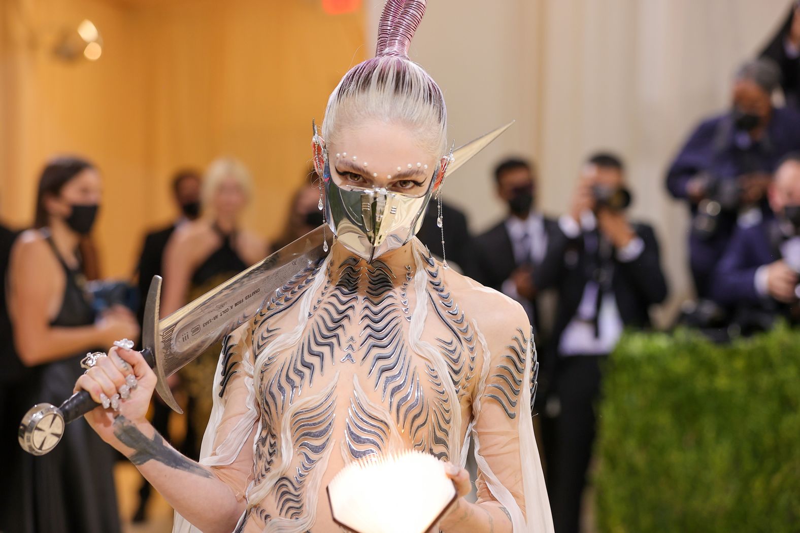 Grimes went full sci-fi and was inspired by "Dune," she said during Vogue's livestreamed coverage of the event. The musician carried a sword made from melted-down guns -- the work of MSCHF, the art collective behind Lil Nas X's controversial "Satan" shoes.