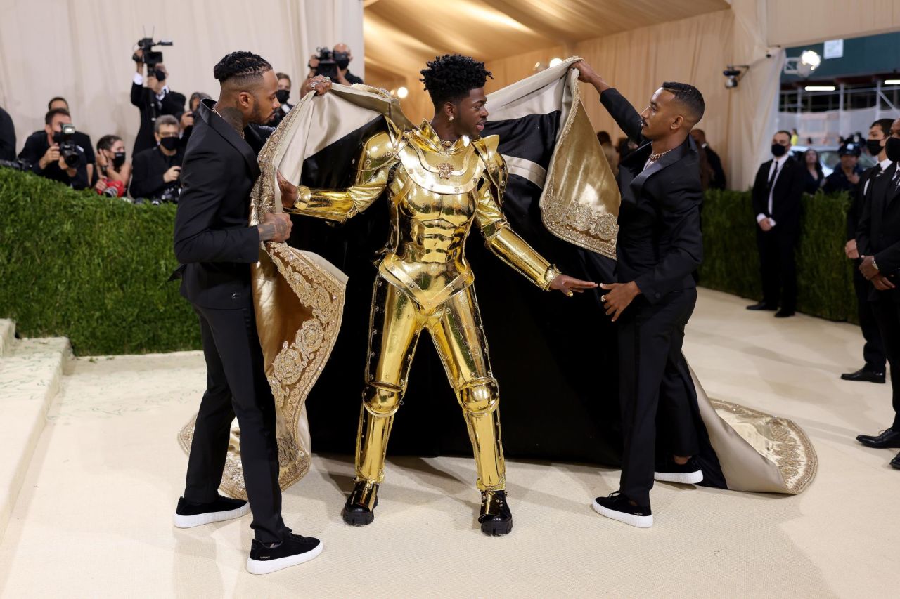 The "Old Town Road" singer then whipped off his cloak to reveal a suit of golden armor.