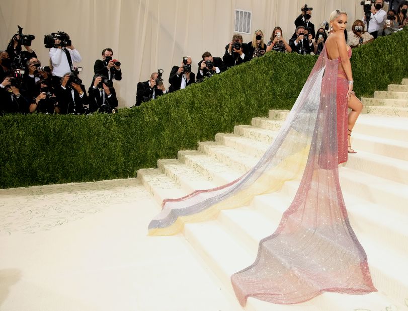 Saweetie's rainbow ombré Christian Cowan dress trailed behind her as she walked the Met's famous stairs. She revealed later told Vogue that the colors were inspired by her Filipino heritage, as well as the Black American heritage flag. 