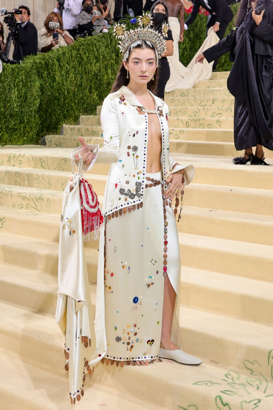 Singer Lorde, who recently released her album "Solar Power," attended wearing a jeweled crown which appeared to feature sun-shaped motifs. She wore a custom embellished Bode gown and carried a small fringed bag.