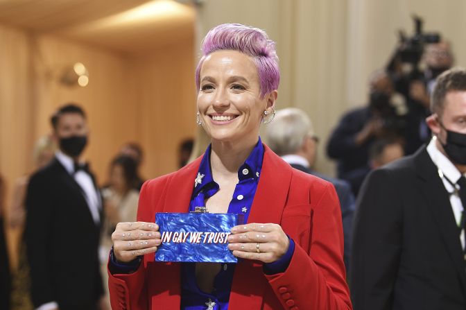 Soccer player Megan Rapinoe arrived in an outfit inspired by the colors of the American flag, wearing a red suit and blue and white starry shirt. She also carried a clutch which read "In gay we trust," which she held up to photographers.