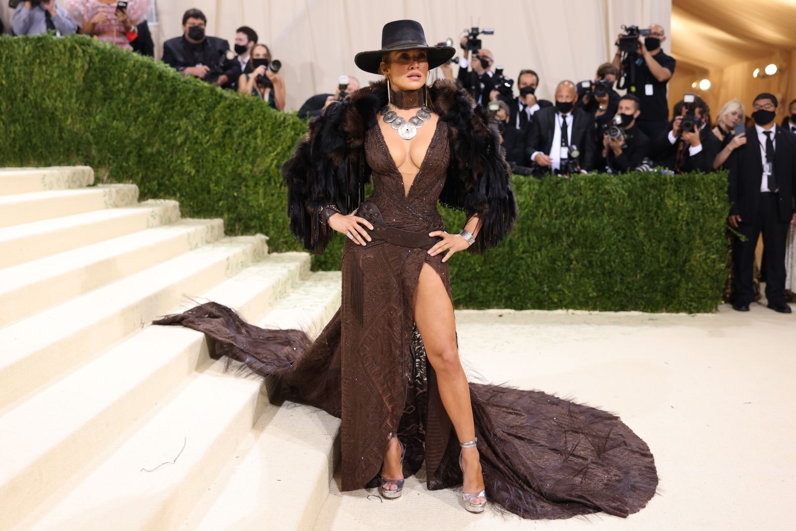 Jennifer Lopez hit the Met Museum steps wearing a custom Ralph Lauren outfit, which channeled the spirit of the Wild West. Donning a faux fur stole, she opted for a deep brown dress embellished with crystal drops, braided silk and leather trims -- topped off with a cowboy hat that completed the look.