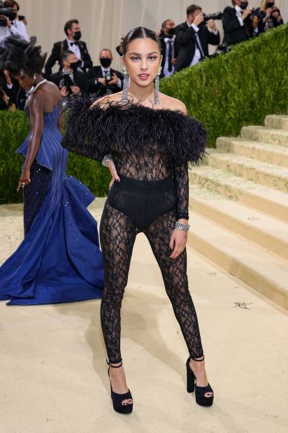 "Good 4 U" singer Olivia Rodrigo made her Met Gala debut dressed in a sheer feather and lace Saint Laurent jumpsuit. She paired the look with a pair of chunky black platform heels.