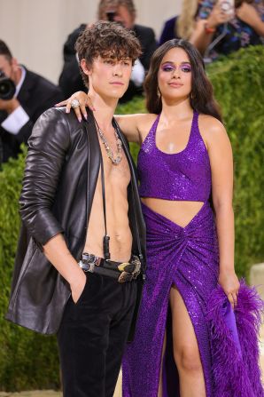 Shawn Mendes and Camilla Cabello arrived together for their Met Gala debut. Mendes went bare-chested under a leather jacket, while Cabello wore a sequined purple cut-out gown.