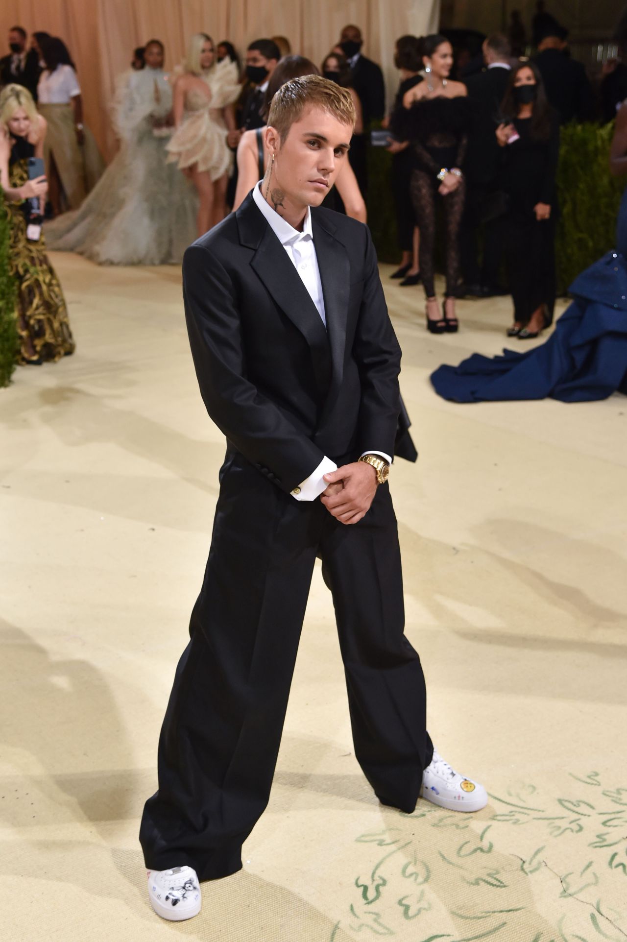 Justin Bieber, who attended with his wife Hailey, opted for a streamlined black and white evening look by his own fashion line Drew House. He was also seen carrying a bag from the label to the Met Gala and wore Air Force 1 sneakers, customized with Drew House branding.