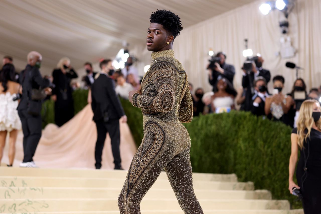 Finally, a group of suited men pulled the armor apart to reveal Lil Nas X's final look: a golden, glittering catsuit.