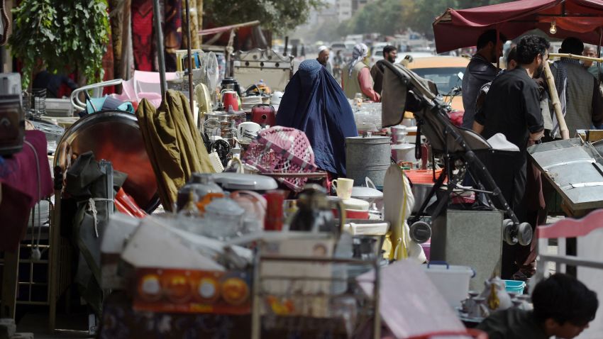 This photo taken on September 12, 2021 shows a woman looking at secondhand household items for sale at a market in the northwest neighbourhood of Khair Khana in Kabul. - Kabul's flea markets are packed full of the belongings that desperate Afghans have sold at rock-bottom prices to fund long journeys to escape the country, or just to pay for food. - TO GO WITH Afghanistan-conflict-fleamarkets,FOCUS by James EDGAR (Photo by WAKIL KOHSAR / AFP) / TO GO WITH Afghanistan-conflict-fleamarkets,FOCUS by James EDGAR (Photo by WAKIL KOHSAR/AFP via Getty Images)