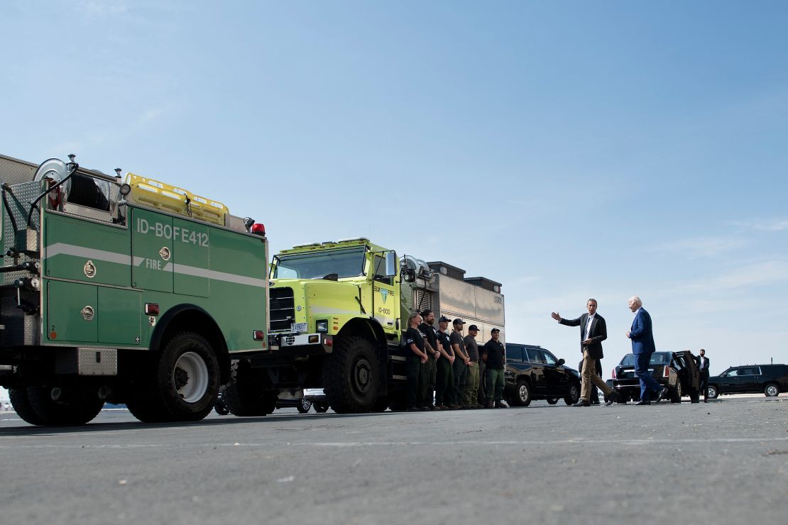 President Biden meets with smoke jumpers and other firefighting professionals during a tour at the National Interagency Fire Center on Monday.