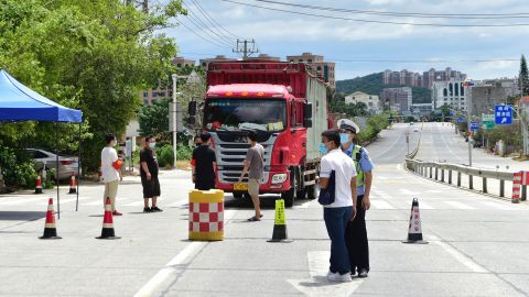 A truck stops at a checkpoint on a road in Xianyou county on September 12. Buses and trains leaving the county have been suspended.