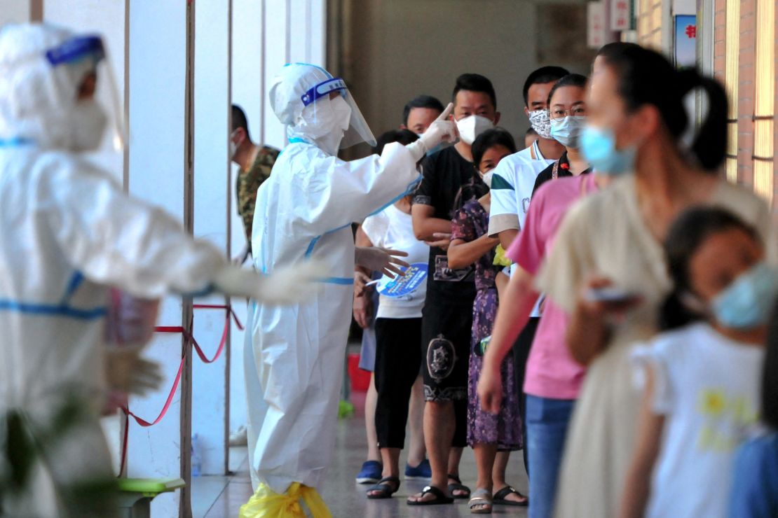 Residents queue to undergo nucleic acid tests for coronavirus in Xianyou county, Putian city, in China's eastern Fujian province on September 13.