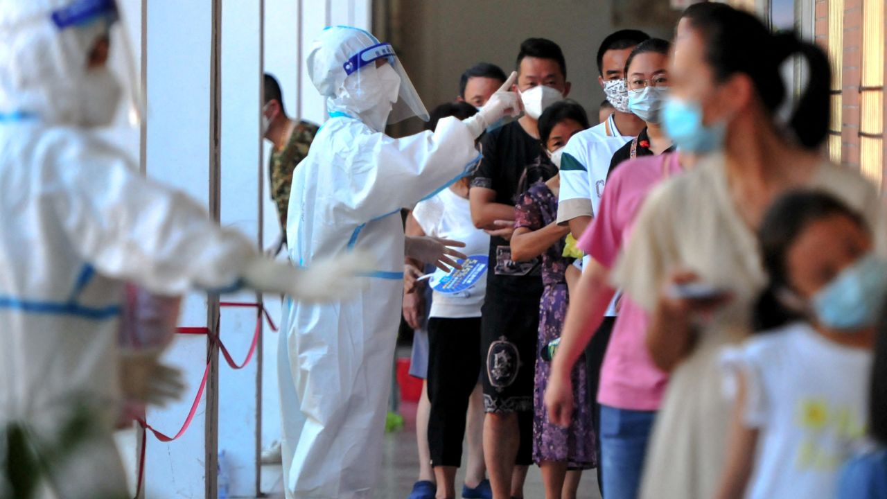 Residents queue to undergo nucleic acid tests for coronavirus in Xianyou county, Putian city, in China's eastern Fujian province on September 13.