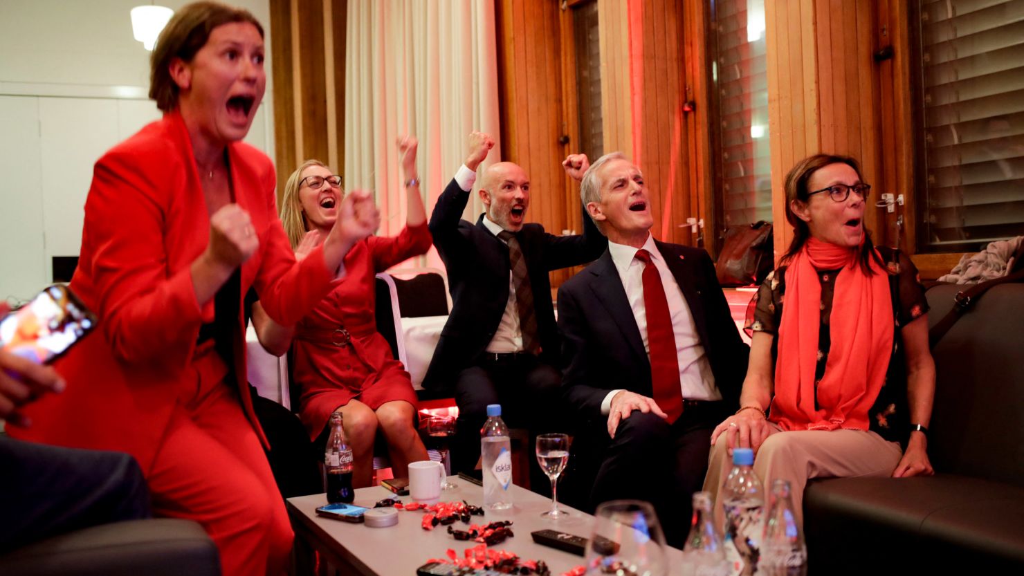 Norway's Labour leader Jonas Gahr Støre, second right, cheers after seeing exit poll results, in Oslo on Monday night. 