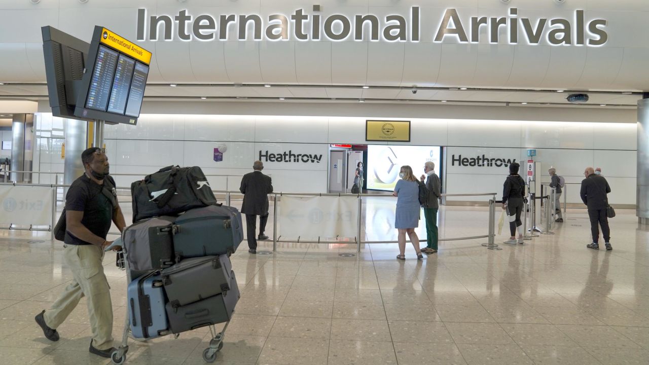 Passengers in the international arrivals hall at London Heathrow Airport on July 29, 2021. 